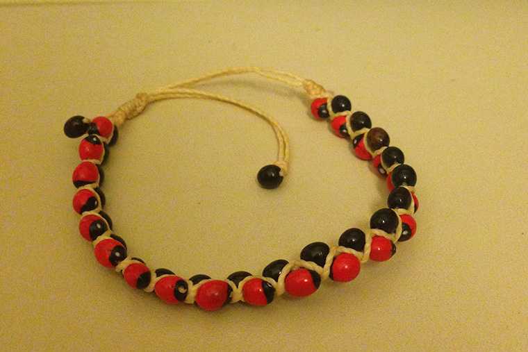 A rosary made from red and black beads.